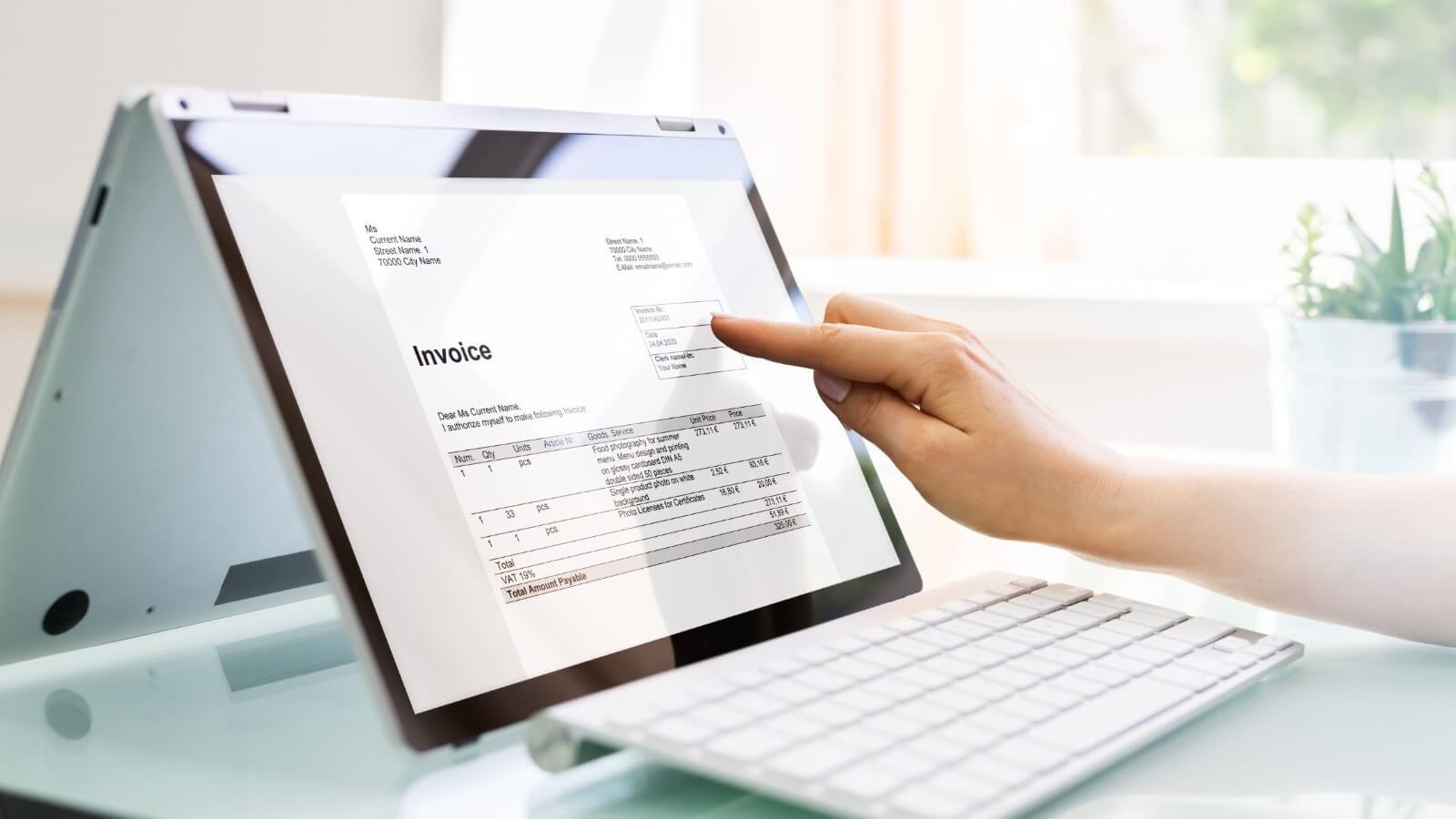 Hand Pointing At A Screen that has invoice information