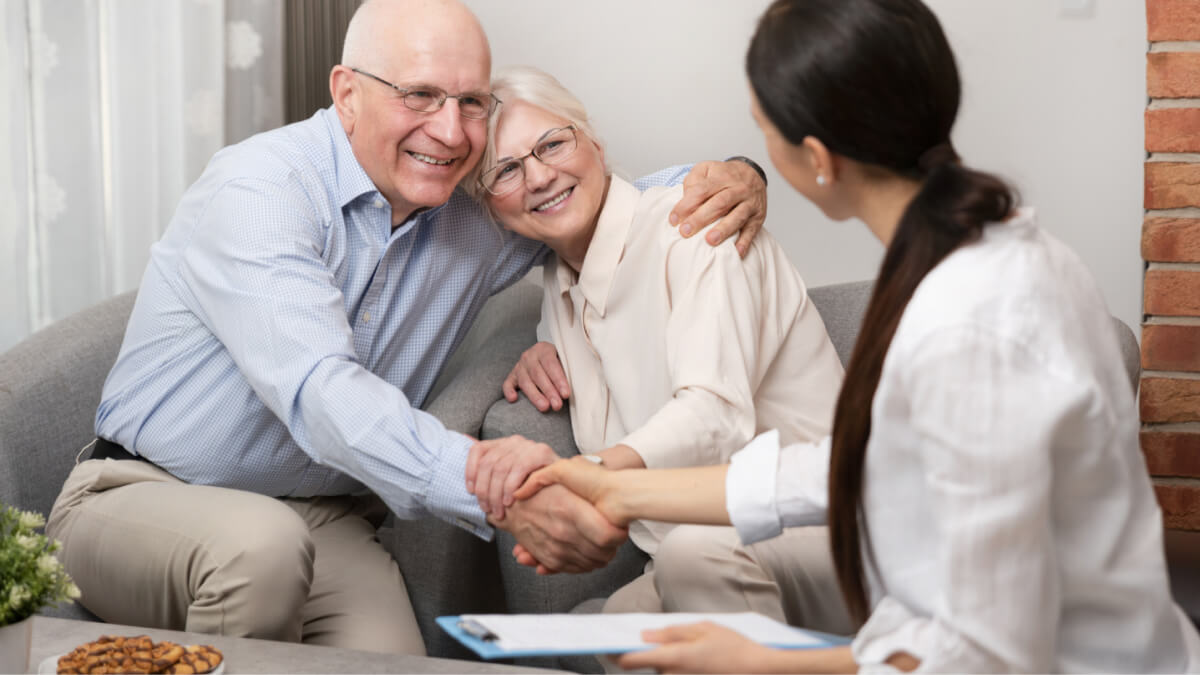 Happy Old Couple Shaking Hands With Young Lady