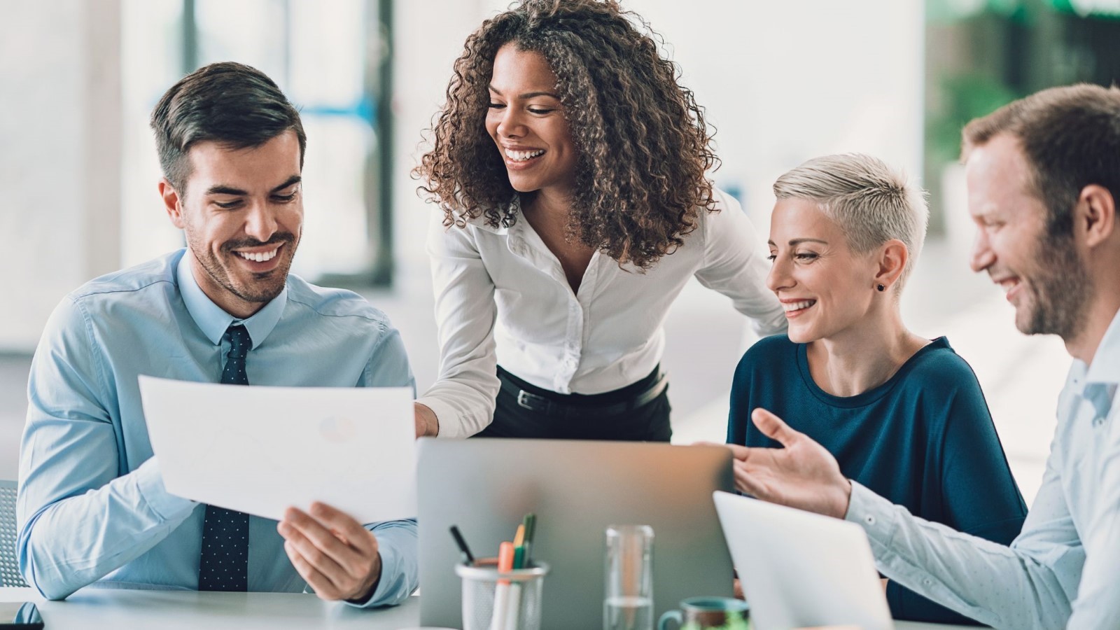 Group of People Looking at a Paper