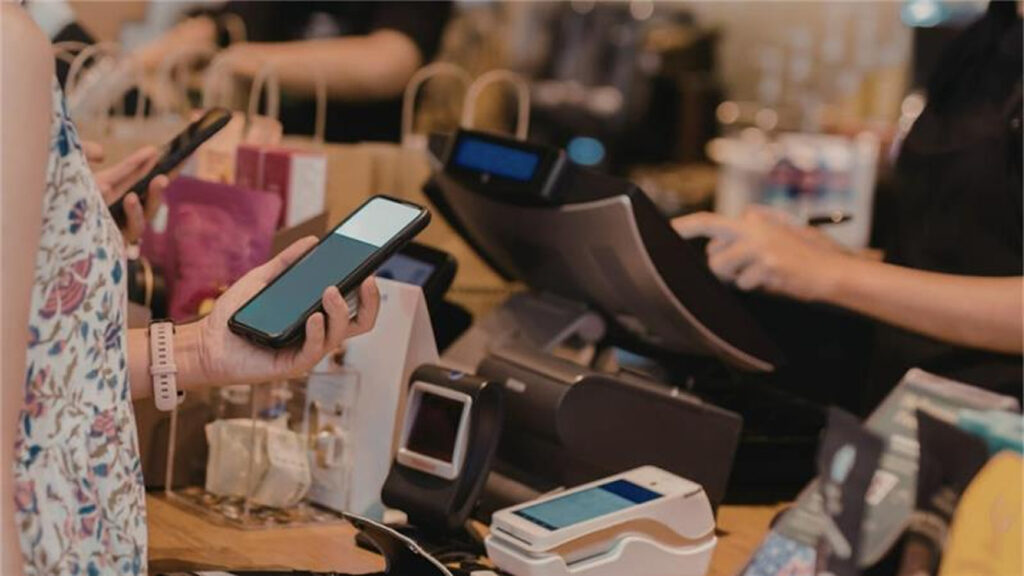 A person using a phone to pay for a purchase
