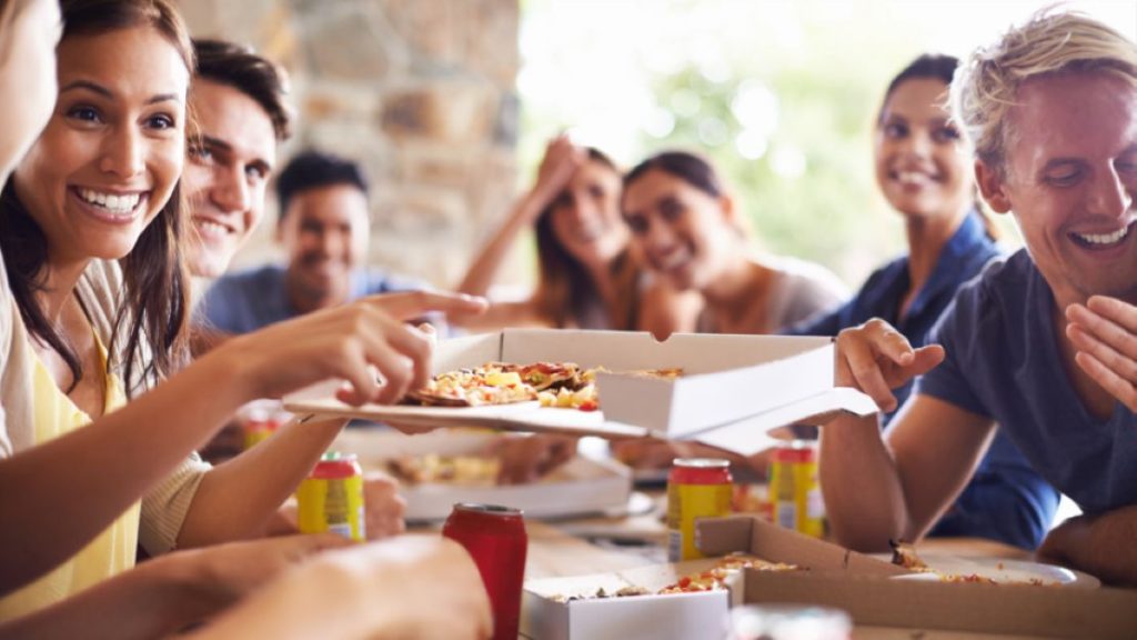 A group of people enjoying pizza