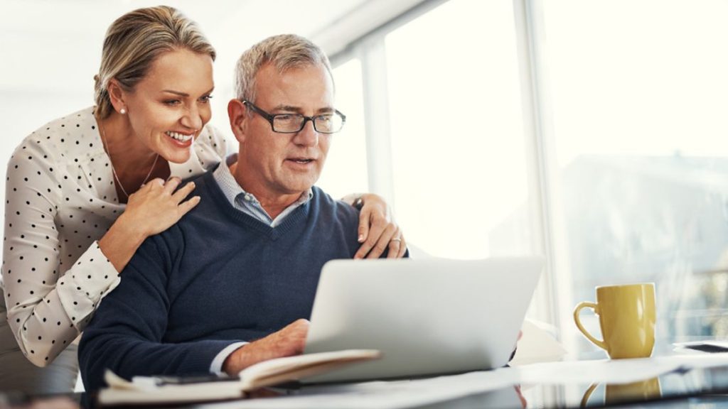 Man and Woman Smiling at the Laptop