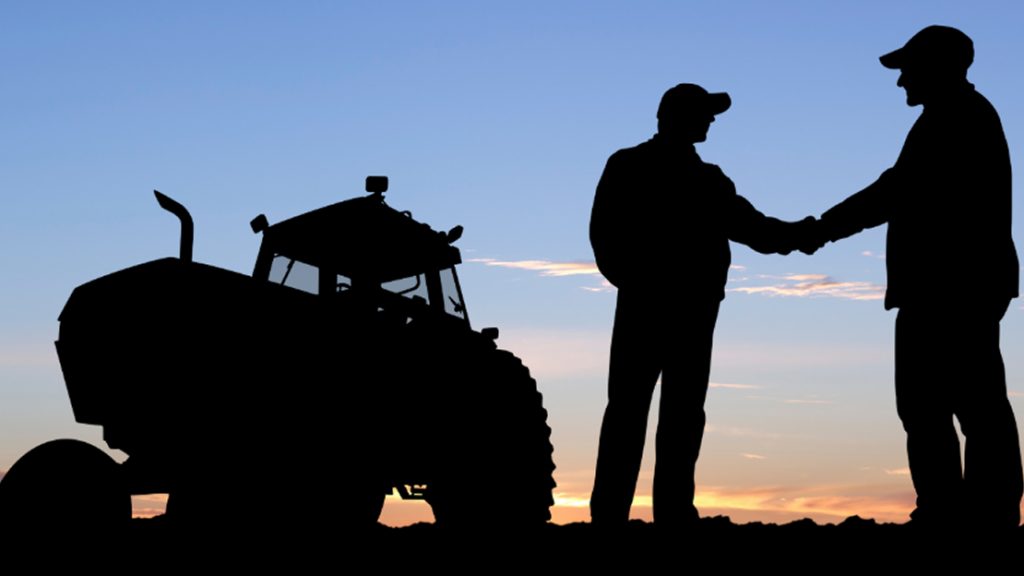 People Handshaking with Tractor at the Background