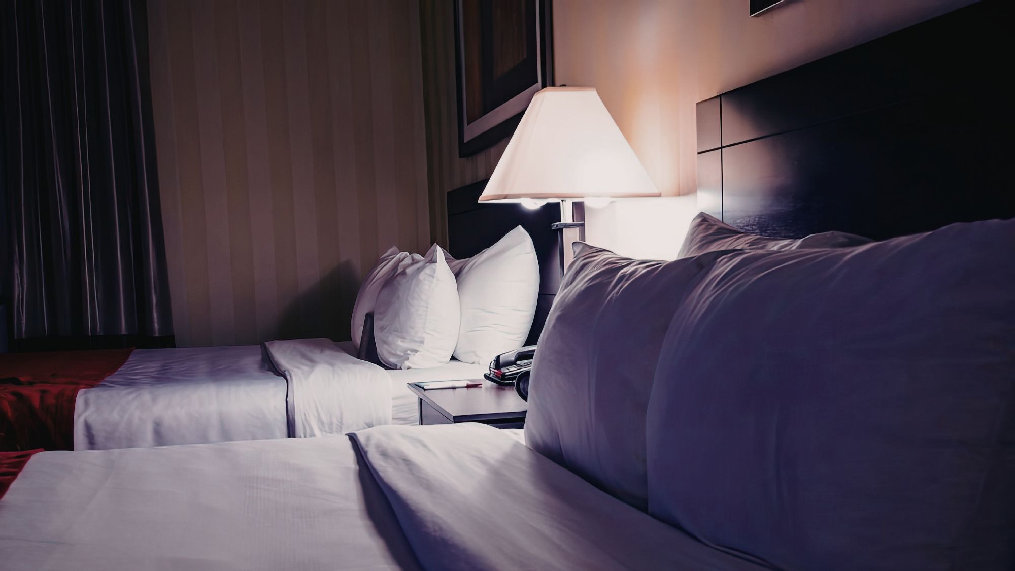 Two Beds in Hotel Room with White Linens