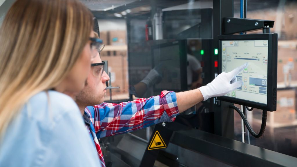 Two people looking at a monitor