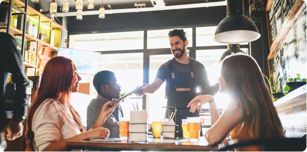 Waiter giving a menu to a customer